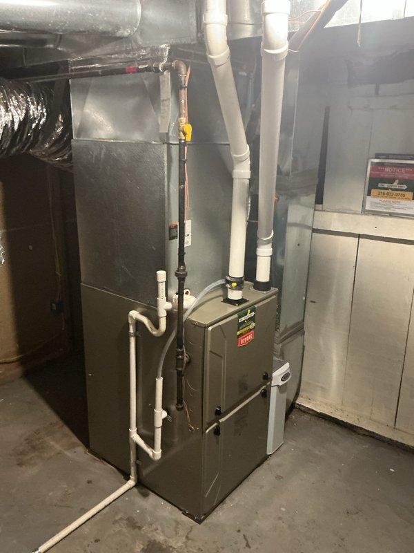 Responded to service call for air conditioning system low on refrigerant. Conducted diagnostic assessment of residential HVAC system located in basement utility area. Evaluated furnace unit, air handler, and associated ductwork and piping connections. Documented existing equipment condition including gas supply lines with shut-off valve, condensate drainage system, PVC venting, and electrical components. Prepared estimate for complete system replacement based on assessment findings.