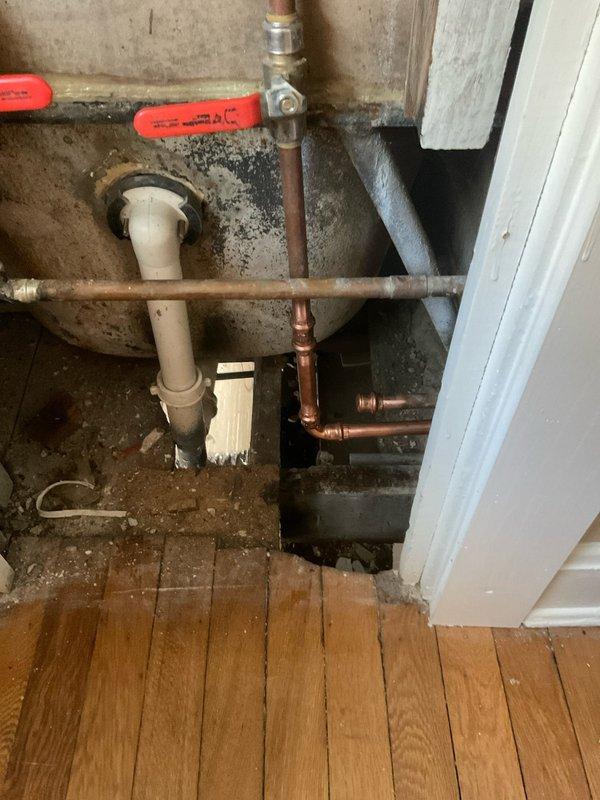 Responded to plumbing system cross-connection issue where cold water line was incorrectly connected to hot water supply. Disconnected the improperly connected cold line from the hot side of the system. Repiped the hot water line correctly to restore proper water supply configuration. Work performed in exposed plumbing compartment with copper supply lines and shut-off valves. System tested and verified operational upon completion.
