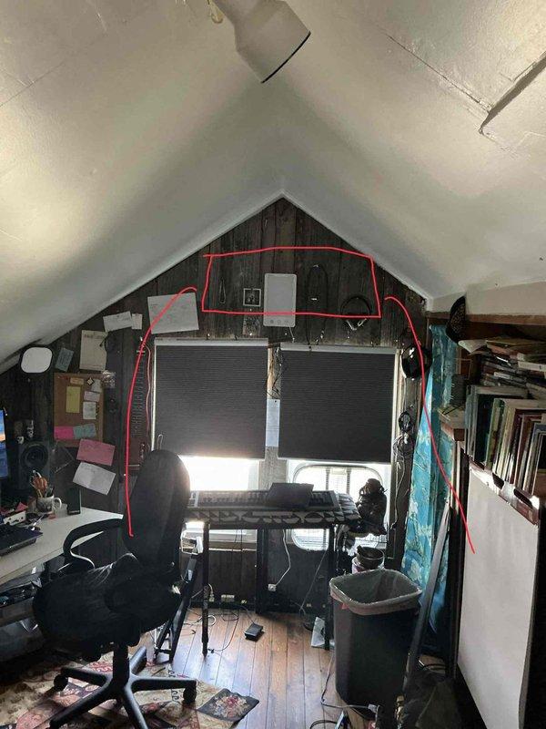 Conducted on-site assessment for mini split installation in converted attic workspace with vaulted ceiling and exposed beam construction. Evaluated space requirements, electrical access, and optimal placement for an 18,000 BTU ductless mini split system to provide heating and cooling to the finished attic area.