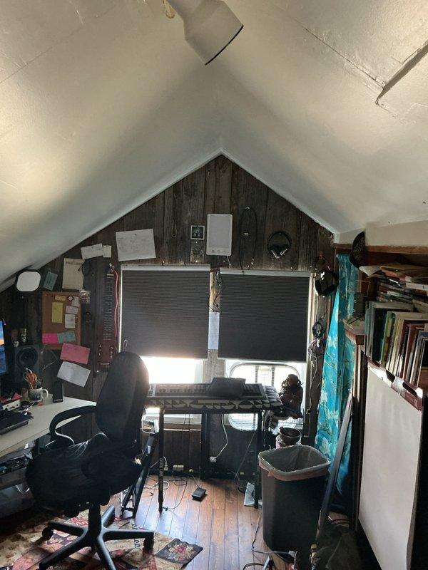 Conducted on-site assessment for mini split installation in converted attic workspace with vaulted ceiling and exposed beam construction. Evaluated space requirements, electrical access, and optimal placement for an 18,000 BTU ductless mini split system to provide heating and cooling to the finished attic area.