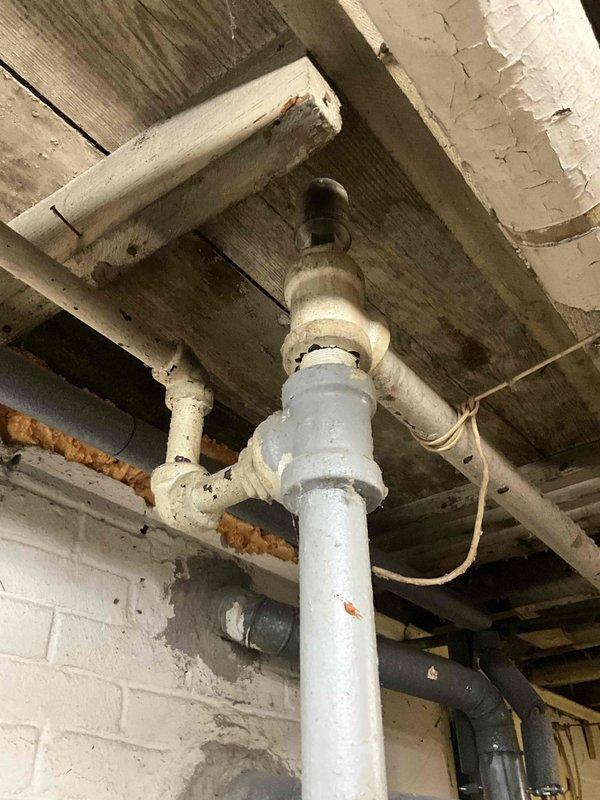 Responded to no heat call for boiler system. Upon arrival, conducted visual inspection of basement mechanical area and documented existing plumbing infrastructure, gas piping, and structural conditions surrounding the heating system. Photographed current installation layout including gas supply lines, venting components, and mounting location to assess equipment accessibility and code compliance requirements for potential boiler replacement or repair recommendations.