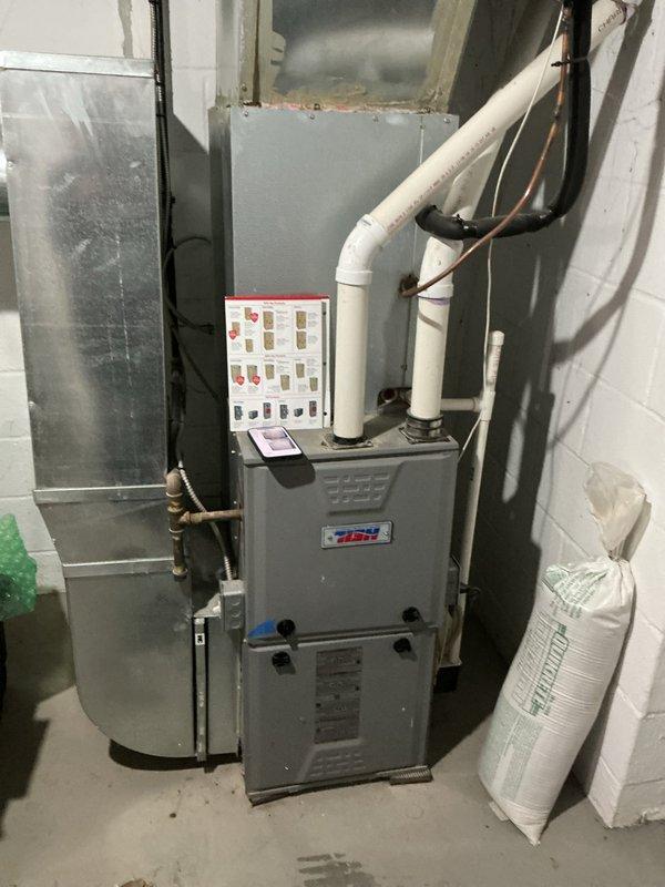 Conducted on-site evaluation of 12-year-old residential furnace system located in basement utility area to provide replacement estimate. Inspected existing gray metal furnace unit, associated PVC venting, condensate drainage system, and connected ductwork. Documented current system configuration including air handler, refrigerant lines, and plumbing connections. Captured photographic documentation of equipment condition and installation layout for estimate preparation. Provided replacement quote and scheduled follow-up appointment with customer requiring advance notification.