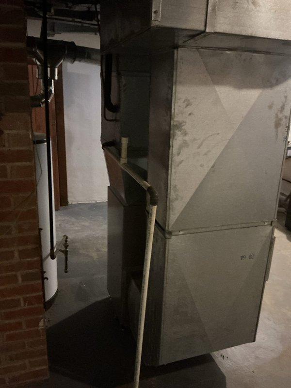 Conducted on-site evaluation of existing HVAC system in basement mechanical room for replacement estimate. Documented current equipment configuration including vertical furnace/air handler unit with 16x25x4 filter specification. Assessed installation environment, ductwork connections, and accessibility for future replacement work. Captured photographic documentation of existing system condition and surrounding workspace to support equipment sizing and installation planning recommendations.