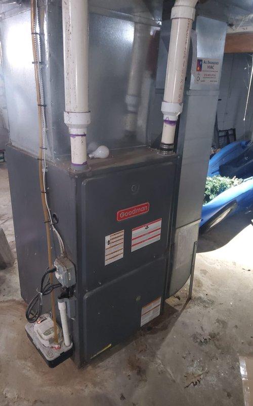 Responded to service call regarding potential carbon monoxide leak identified by gas company. Upon arrival, performed comprehensive safety inspection of Goodman furnace system. Visual examination revealed extensive corrosion and rust damage on heat exchanger components and internal metal surfaces, indicating advanced deterioration from prolonged moisture exposure. The corrosion exhibited heavy oxidation with pitting and flaking, particularly on critical heat exchanger surfaces where structural integrity is essential for safe operation. This level of deterioration creates pathways for combustion gases, including carbon monoxide, to escape into the living space rather than being properly vented. Documented all findings with photographs showing corroded components and overall unit condition. Confirmed gas company's assessment that furnace poses carbon monoxide safety hazard due to compromised heat exchanger. Advised customer that unit requires immediate replacement as heat exchanger failu