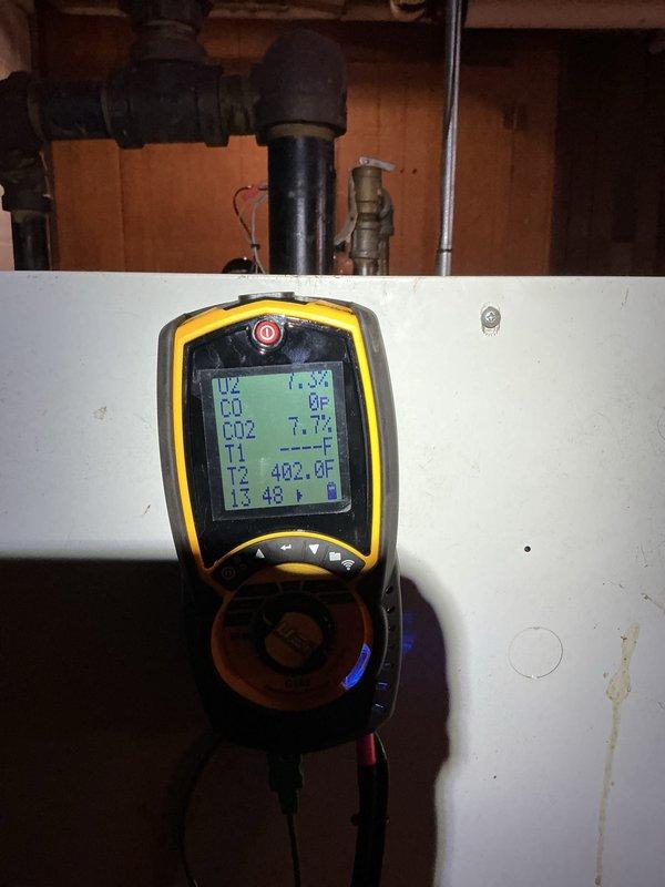 Performed annual maintenance on 20-year-old Slant/Fin boiler system. Removed front access panel to inspect internal components including burner assembly, heat exchanger, gas valve, and control board. Verified all electrical connections, wire bundles, and control circuits were secure and functioning properly. Conducted combustion analysis using digital diagnostic meter, recording stack temperature of 482°F and ambient temperature readings. All measured parameters including CO and CO2 levels were within acceptable operating ranges. Inspected gas piping, connections, and safety controls for proper operation. System tested and returned to normal service with all components operating as designed.
