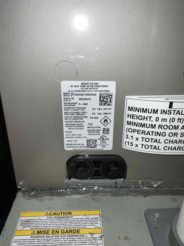 # HVAC System Installation

Successfully completed a full air conditioning and evaporator coil replacement in the mechanical room. Removed the existing system and installed a new CVA1036172MAA40A indoor heat pump/air conditioner section with matching coil assembly. The new air handler unit was properly positioned and secured adjacent to the existing furnace equipment. Installed and wired a new control relay box on the adjacent wall, running appropriate electrical conduits and connections to the main unit. All electrical connections were terminated according to manufacturer specifications and code requirements. Verified proper refrigerant line connections at the coil ports and confirmed all safety labels and documentation were in place. System was tested for proper operation with all indicator lights functioning correctly. Installation meets UL certification standards and manufacturer's minimum clearance requirements.