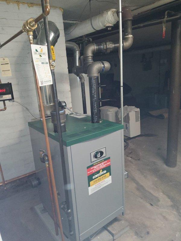 Successfully completed full steam boiler replacement in residential basement, including removal of existing unit and installation of new gas-fired steam boiler with updated venting system. Upgraded main venting with two new main vents to improve system air purging and enhance steam distribution efficiency. Installed new automatic water feeder to maintain proper boiler water level and prevent low-water conditions. Replaced three radiator vents throughout the building to ensure proper air elimination and balanced heat delivery to all zones. All copper piping connections were made to code, and black iron gas piping was properly installed and tested for leaks. System was pressure tested, fired up, and cycled to verify proper operation of all safety controls and limit switches. Confirmed adequate steam production and distribution to all radiators with proper condensate return.