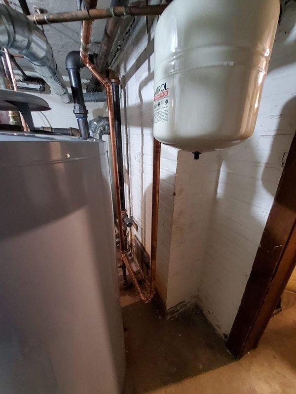 Replaced defective boiler piping in mechanical room, installing new copper pipe runs with appropriate fittings to restore proper system operation. All connections were properly soldered and tested, with expansion tank and associated components reconnected to ensure reliable hydronic heating system performance.