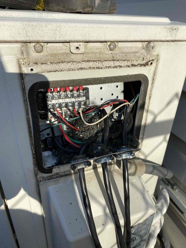 Responded to E1 error code displaying on all three 5-year-old air conditioning units. Upon arrival, inspected electrical control panels and internal circuit boards on each system. Found accumulated dirt, debris, and weathering on exterior junction boxes and internal electronic components affecting proper operation. Accessed control boards revealing discolored PCBs, compromised wire connections, and dust buildup throughout electrical compartments. Cleaned terminal blocks, inspected all wire connections at junction points, and verified proper electrical continuity. Cleared debris from circuit board cavities and wire bundles to restore proper airflow around sensitive electronic components. Reset error codes and cycled all three units through startup sequences to confirm proper operation and error code resolution.