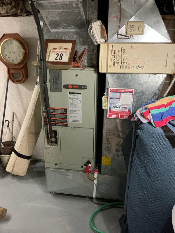 Performed on-site evaluation of existing 41-year-old Trane air handler system located in basement utility area. Documented current equipment condition, configuration, and installation specifications through photographic assessment. Prepared comprehensive replacement quote for complete heat pump system upgrade to address aging HVAC equipment that has exceeded its expected service life.