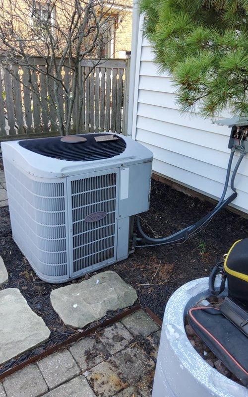 Responded to general air conditioning service call and performed routine maintenance on residential AC system. Upon arrival, conducted thorough inspection of outdoor condenser unit, which was found properly mounted on concrete pavers with adequate clearance from structure. Verified refrigerant line sets were secure and properly insulated along exterior wall. Cleaned condenser coils, inspected electrical connections, and confirmed unit operational status. System operating within normal parameters at time of service completion.