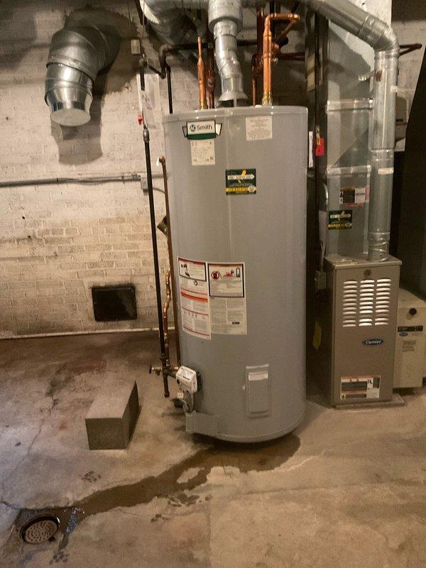 Responded to service call for water heater with pilot light failure and no hot water production. Upon arrival, inspected 5-year-old residential tanked water heater located in basement utility area. Diagnosed pilot light ignition system malfunction preventing burner operation. Performed troubleshooting procedures on thermocouple, gas control valve, and pilot assembly. Cleaned pilot orifice and thermocouple sensor to remove debris and carbon buildup. Verified proper gas supply and pressure to unit. Successfully relit pilot light and confirmed stable flame. Tested burner ignition sequence and verified proper heating cycle operation. Confirmed hot water restoration and proper system functionality before completing service call.