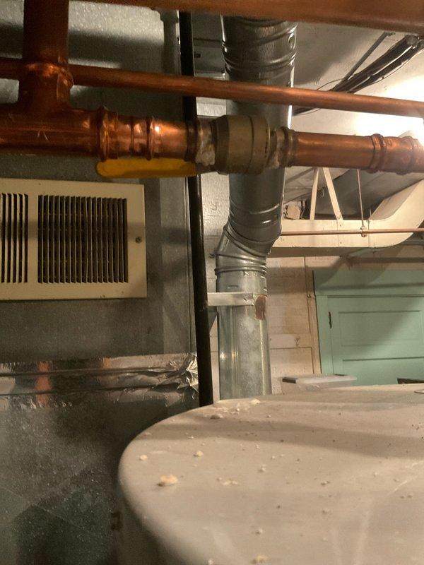 Responded to service call for water heater with pilot light failure and no hot water production. Upon arrival, inspected 5-year-old residential tanked water heater located in basement utility area. Diagnosed pilot light ignition system malfunction preventing burner operation. Performed troubleshooting procedures on thermocouple, gas control valve, and pilot assembly. Cleaned pilot orifice and thermocouple sensor to remove debris and carbon buildup. Verified proper gas supply and pressure to unit. Successfully relit pilot light and confirmed stable flame. Tested burner ignition sequence and verified proper heating cycle operation. Confirmed hot water restoration and proper system functionality before completing service call.