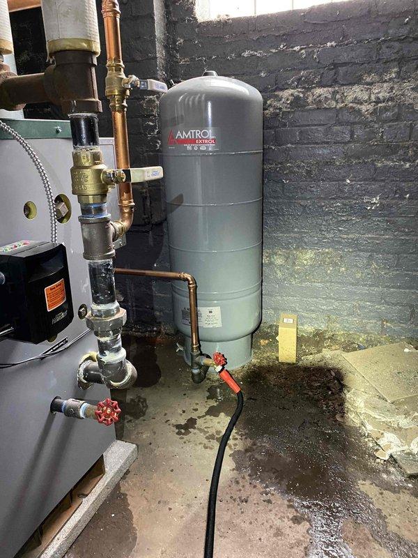 Replaced failed expansion tank on hydronic heating system with new Amtrol pressure tank. Installed new temperature and pressure relief valve with proper discharge piping to code. Repiped sections of copper supply lines with new brass fittings and shut-off valves to ensure proper system operation and eliminate leaks. All connections pressure tested and system returned to normal operation.