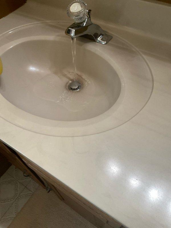 Responded to a plumbing service call for a clogged bathroom sink and loose faucet handle in a 90-year-old residential property. Successfully cleared the drain obstruction in the bathroom sink using appropriate drain cleaning methods to restore proper water flow and drainage. Tightened and secured the loose handle on the downstairs Moen faucet assembly, ensuring proper operation and eliminating wobble or movement during use.