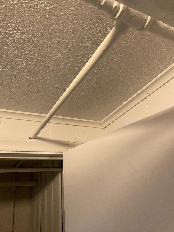 Responded to service call for leaking water pipe connected to tanked water heater originally installed in 2018. Upon arrival at 112-year-old residential property, performed visual inspection of plumbing system and identified source of leak at pipe connection point. Confirmed no water damage to surrounding ceiling, walls, or structural components at time of inspection. 

Assessed condition of existing PVC piping network in basement utility area, noting proper routing and installation of water supply lines including PEX tubing and associated shut-off valves. Inspected brass fittings and connections at pipe intersections for signs of deterioration or compromise. Evaluated water heater installation and verified all supply and discharge lines for proper function and integrity.

Tightened connection at leak source and tested system under normal operating pressure to confirm repair effectiveness. Monitored all visible pipe sections, joints, and fittings for additional moisture or potential fa
