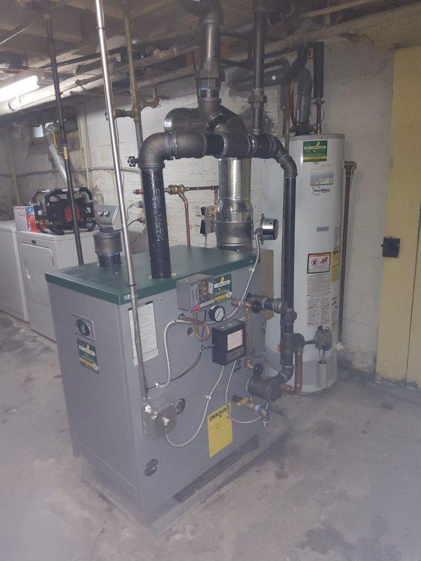 Completed full steam boiler replacement including removal of existing unit and installation of new gas-fired steam boiler. Replaced boiler feed pump, automatic water feeder, and thermostat to ensure proper system operation. Converted copper header piping to black iron pipe per code requirements and reconfigured Hartford loop for proper boiler protection and condensate return. All piping connections pressure tested, system filled, and boiler fired to verify proper steam distribution throughout existing radiator system. Customer notified upon completion of installation.