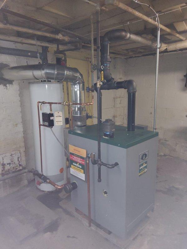 Completed full steam boiler replacement including removal of existing unit and installation of new gas-fired steam boiler. Replaced boiler feed pump, automatic water feeder, and thermostat to ensure proper system operation. Converted copper header piping to black iron pipe per code requirements and reconfigured Hartford loop for proper boiler protection and condensate return. All piping connections pressure tested, system filled, and boiler fired to verify proper steam distribution throughout existing radiator system. Customer notified upon completion of installation.