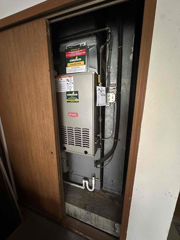 Completed installation of new Bryant residential furnace unit in interior closet space. Mounted and secured furnace within wood-framed utility closet, established all necessary ductwork connections to existing distribution system, and installed PVC condensate drain piping. Performed commissioning procedures including dual-port manometer pressure testing, which confirmed proper static pressure readings of 0.350 inches water column on both supply and return sides, verifying system is operating within manufacturer specifications and optimal airflow parameters.