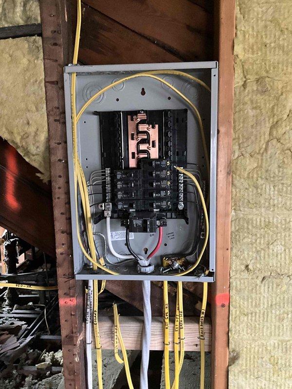 Conducted on-site assessment for mini split installation on third floor of residential property. Evaluated exterior wall mounting location, verified electrical service capacity at existing meter bank, and inspected interior electrical panel to confirm adequate breaker availability and proper grounding for new system installation.