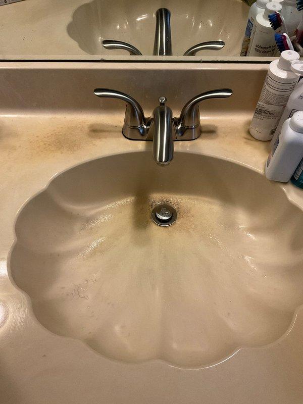 Responded to service call for bathroom sink faucet with continuously turning valve handle. Upon inspection, found worn internal cartridge mechanism causing handle to spin without resistance. Disassembled two-handle centerset faucet assembly and replaced faulty cartridge, restoring proper operation and water control. Additionally inspected toilet per customer request and identified worn flapper valve causing intermittent running; adjusted fill valve and replaced flapper to resolve issue.