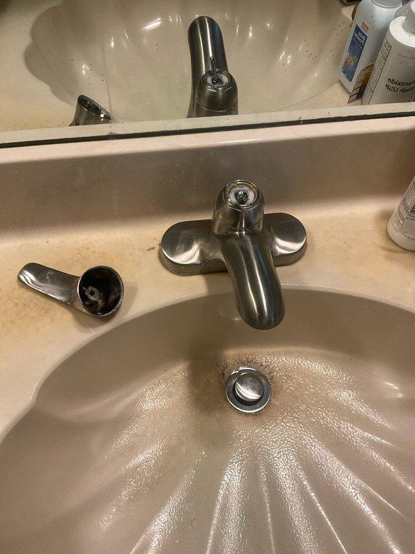 Responded to service call for bathroom sink faucet with continuously turning valve handle. Upon inspection, found worn internal cartridge mechanism causing handle to spin without resistance. Disassembled two-handle centerset faucet assembly and replaced faulty cartridge, restoring proper operation and water control. Additionally inspected toilet per customer request and identified worn flapper valve causing intermittent running; adjusted fill valve and replaced flapper to resolve issue.