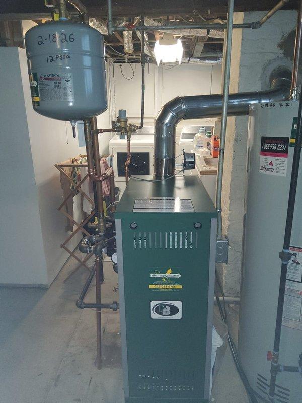 Completed installation of new Peerless MI-e-04 hot water boiler with new circulating pump in basement mechanical room. Integrated unit with existing UNICO high velocity system, hot water coil, Amtrol expansion tank, backflow preventer, and pressure reducing valve using existing 1" copper piping. All equipment tested and operational with proper pressure settings confirmed.