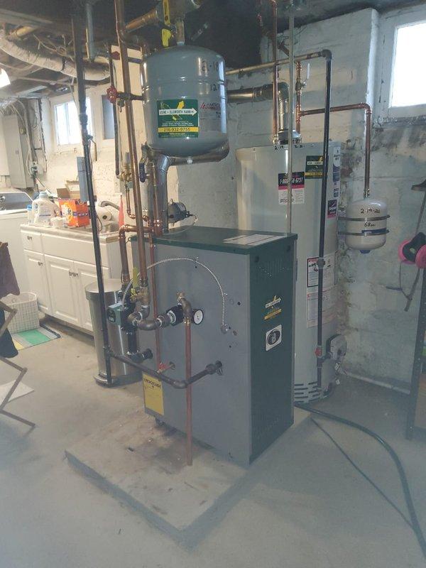 Completed installation of new Peerless MI-e-04 hot water boiler with new circulating pump in basement mechanical room. Integrated unit with existing UNICO high velocity system, hot water coil, Amtrol expansion tank, backflow preventer, and pressure reducing valve using existing 1" copper piping. All equipment tested and operational with proper pressure settings confirmed.