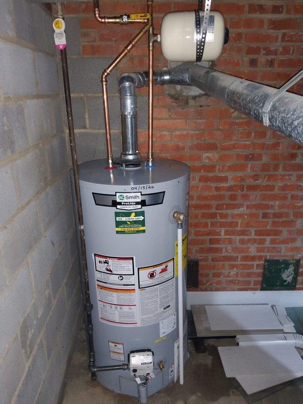 Responded to service call for 10-year-old A.O. Smith tanked water heater experiencing leakage from the bottom of the unit. Upon inspection, confirmed active leak originating from lower section of tank, indicating internal tank failure typical of units in this age range. Documented existing installation including copper supply lines, yellow-handled shut-off valve, expansion tank mounted on adjacent wall, and temperature/pressure relief valve configuration. Photographed water heater showing manufacturer labels, specifications, and overall system setup in basement utility area. Provided customer with comprehensive replacement quote due to non-repairable nature of tank failure.