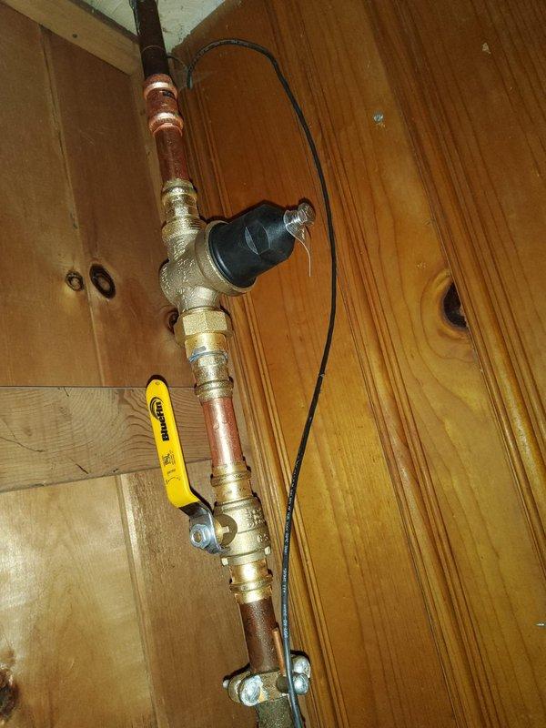 Responded to service call for 10-year-old A.O. Smith tanked water heater experiencing leakage from the bottom of the unit. Upon inspection, confirmed active leak originating from lower section of tank, indicating internal tank failure typical of units in this age range. Documented existing installation including copper supply lines, yellow-handled shut-off valve, expansion tank mounted on adjacent wall, and temperature/pressure relief valve configuration. Photographed water heater showing manufacturer labels, specifications, and overall system setup in basement utility area. Provided customer with comprehensive replacement quote due to non-repairable nature of tank failure.
