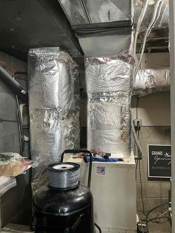 Conducted estimate for complete ductwork replacement following damage from tree impact to residence. Assessed existing HVAC system installation including air handler unit, vertical supply ducts with reflective foil insulation, flexible ductwork connections, condensate pump assembly, and electrical components to determine scope of repairs needed for full ductwork restoration.