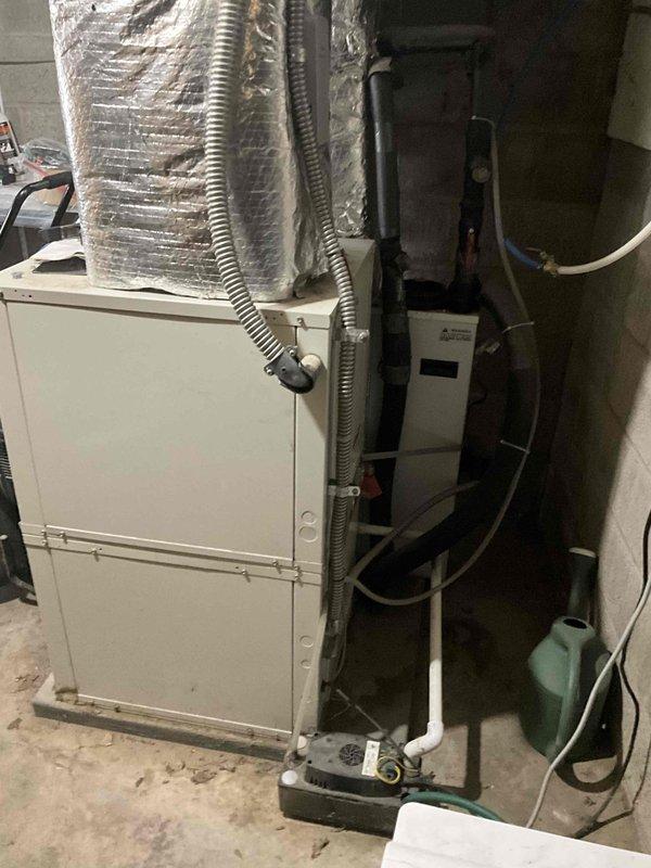 Conducted estimate for complete ductwork replacement following damage from tree impact to residence. Assessed existing HVAC system installation including air handler unit, vertical supply ducts with reflective foil insulation, flexible ductwork connections, condensate pump assembly, and electrical components to determine scope of repairs needed for full ductwork restoration.