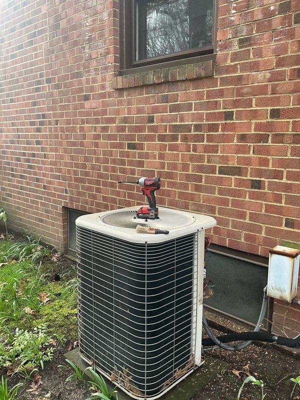 # HVAC Maintenance - Cooling System Service

Performed comprehensive preseason air conditioning tune-up and inspection on residential cooling system. Upon arrival, contacted property occupant via provided phone number to confirm appointment and estimated time of arrival.

## Exterior Unit Inspection

Conducted thorough examination of outdoor condenser unit positioned against building exterior. Inspected condenser coils for debris accumulation and airflow restrictions. Cleaned condenser fins and coils to ensure optimal heat transfer efficiency. Verified proper clearance around unit for adequate ventilation. Examined electrical disconnect box mounted on exterior wall for secure connections and proper operation. Assessed unit mounting and levelness on pad. Checked refrigerant line insulation for deterioration or damage.

## Interior Component Service

Accessed control compartment and inspected electrical components, circuit board, and wiring connections. Verified all terminal blocks and w