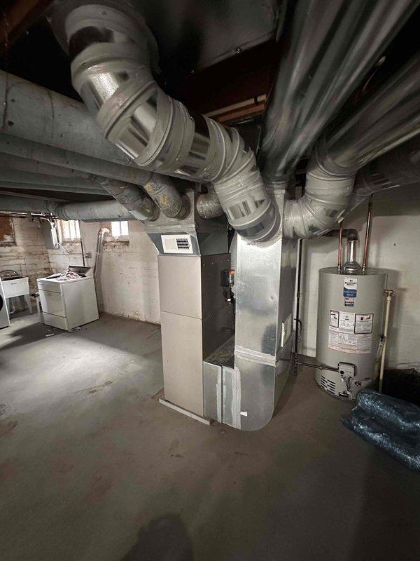 Completed full HVAC system installation in basement mechanical room, including new Bryant furnace, evaporator coil, air conditioning condenser unit, and Ecobee smart thermostat. Installed and configured all ductwork connections with proper trunk lines and branch takeoffs, ensuring adequate airflow distribution throughout the residence. Tied back existing return air ducts to new system, verifying proper sizing and sealed all connections to prevent air leakage. Ran electrical conduit and wiring to code specifications, connecting all components to dedicated circuits with appropriate disconnect switches. Commissioned entire system by testing heating and cooling cycles, verifying thermostat communication and programming, checking refrigerant charge levels, and confirming proper condensate drainage. All equipment operational and performing to manufacturer specifications upon completion.