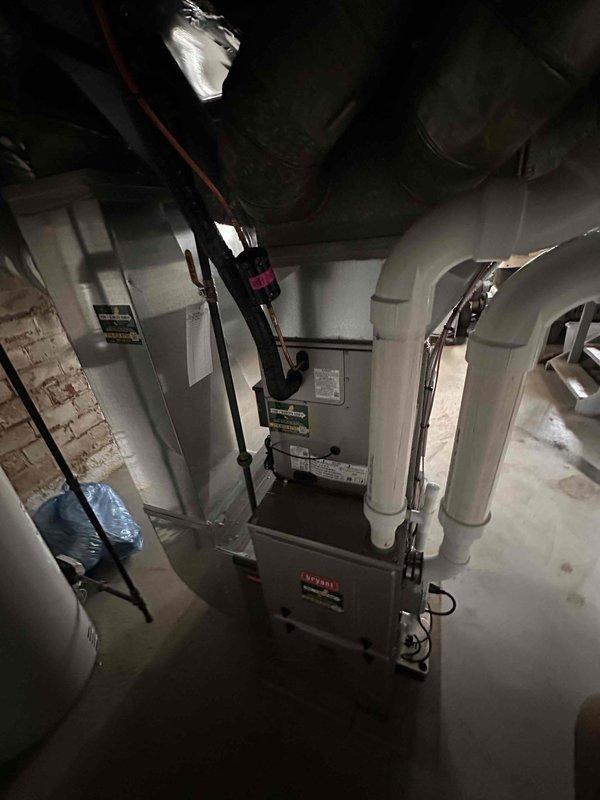 Completed full HVAC system installation in basement mechanical room, including new Bryant furnace, evaporator coil, air conditioning condenser unit, and Ecobee smart thermostat. Installed and configured all ductwork connections with proper trunk lines and branch takeoffs, ensuring adequate airflow distribution throughout the residence. Tied back existing return air ducts to new system, verifying proper sizing and sealed all connections to prevent air leakage. Ran electrical conduit and wiring to code specifications, connecting all components to dedicated circuits with appropriate disconnect switches. Commissioned entire system by testing heating and cooling cycles, verifying thermostat communication and programming, checking refrigerant charge levels, and confirming proper condensate drainage. All equipment operational and performing to manufacturer specifications upon completion.