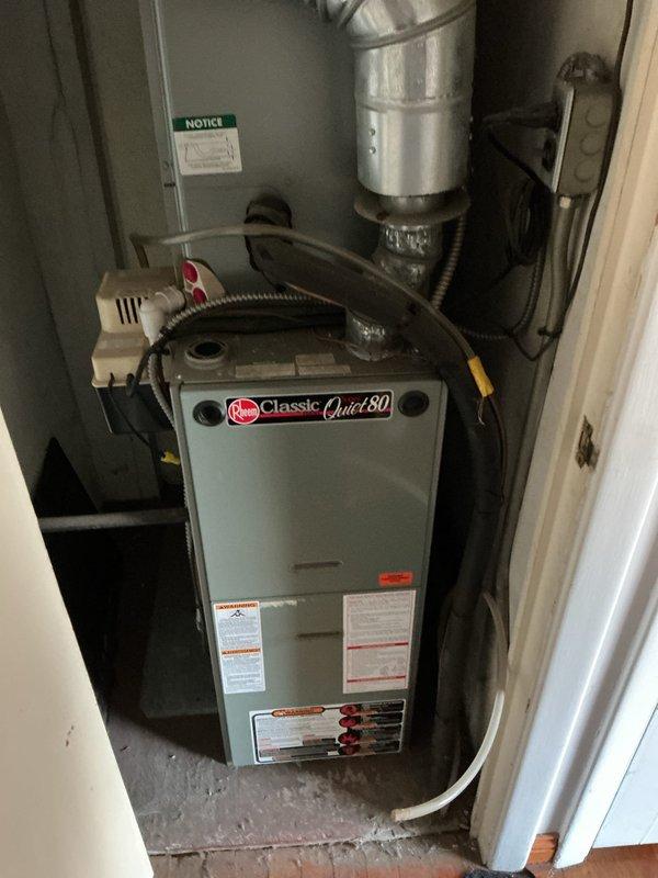 Conducted comprehensive assessment of existing residential HVAC system for replacement estimate. Evaluated current Rheem Classic Quiet 80 gas furnace installation located in interior utility closet, documenting equipment condition, configuration, and spatial constraints. Photographed existing system including furnace unit, supply ductwork, electrical connections, and associated plumbing components to determine replacement specifications and identify any modification requirements for new equipment installation.