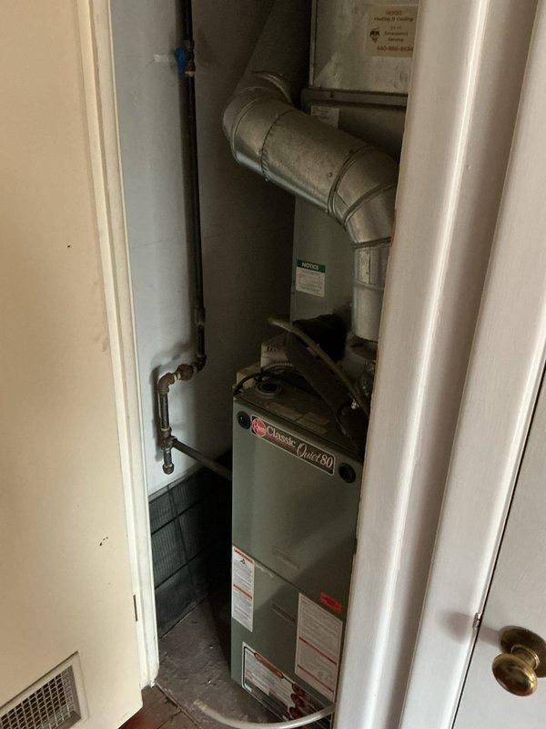 Conducted comprehensive assessment of existing residential HVAC system for replacement estimate. Evaluated current Rheem Classic Quiet 80 gas furnace installation located in interior utility closet, documenting equipment condition, configuration, and spatial constraints. Photographed existing system including furnace unit, supply ductwork, electrical connections, and associated plumbing components to determine replacement specifications and identify any modification requirements for new equipment installation.
