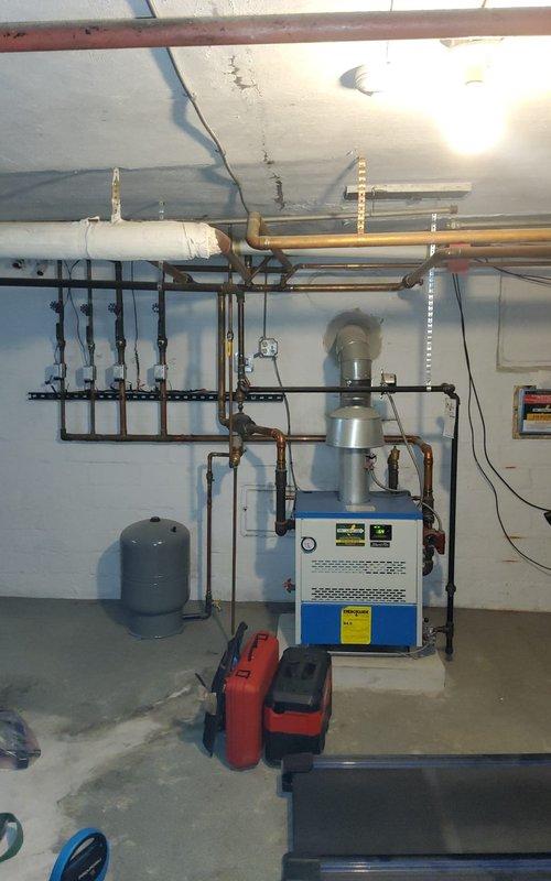 Completed comprehensive maintenance on residential HVAC system including hot water boiler and air conditioning unit. Inspected heat exchanger components, noting age-related surface oxidation on finned tubes while confirming structural integrity and proper heat transfer capability. Performed standard maintenance procedures on basement mechanical equipment, checked all copper piping connections, verified expansion tank operation, and ensured proper ventilation system function with all components operating within normal parameters.