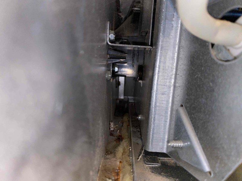 Responded to service call for furnace leaking water at base of 20-year-old unit. Upon arrival, performed visual inspection and documented conditions with photographs. Identified rust-colored staining and water damage on metal base panels and interior components, indicating active or recent water leakage. Inspected condensate drain system, evaporator coil area, and heat exchanger for potential leak sources. Given the age of the equipment and extent of corrosion observed, discussed repair versus replacement options with homeowner. Provided recommendations for addressing the water leak issue and preventing further damage to the unit and surrounding area.