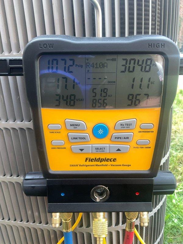 Performed preventive maintenance on ADP evaporator coil system utilizing R410A refrigerant with TXV installed (Model GU2329G0117DB1MS4AP). Connected Fieldpiece SMAN manifold gauges to outdoor condensing unit and verified system pressures and temperatures, recording low side pressure of 72 psig and high side pressure of 304.8 psig with operating temperature of 111°F, confirming proper refrigerant charge and system operation within manufacturer specifications.