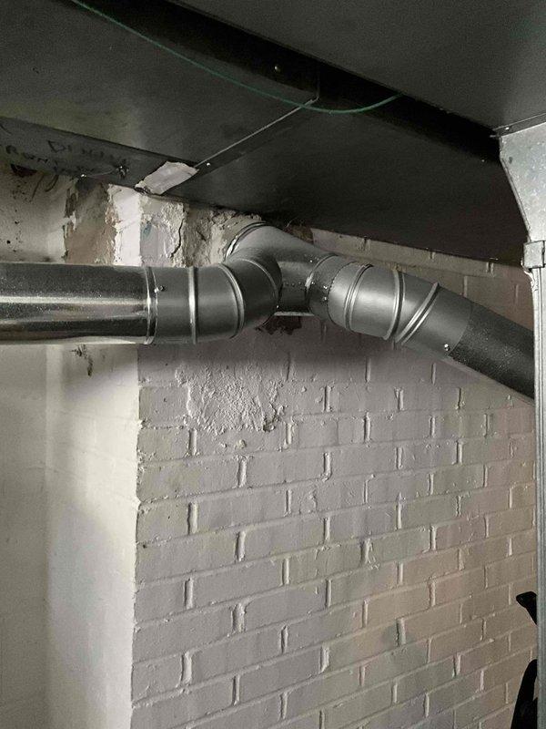 Conducted on-site assessment for complete furnace and air conditioning system replacement. Evaluated existing basement HVAC installation including current furnace unit, air handler, and associated ductwork system. Documented equipment specifications, existing infrastructure conditions, and spatial requirements for new system installation. Photographed current setup showing beige furnace with metallic ductwork, adjacent air handler, copper refrigerant lines, and branch duct configuration. Noted wall conditions and provided comprehensive replacement estimate for new heating and cooling equipment.