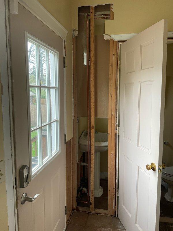 Responded to emergency plumbing repair at vacant property with freeze-damaged water lines. Cut out and replaced multiple burst ProPress fittings and split copper waterlines in wall and ceiling cavities. Opened drywall in entryway wall and ceiling to access damaged sections of plumbing system. Replaced main water shut-off valve during repair process. Pressurized system and conducted comprehensive leak testing throughout the home to verify integrity of all repairs and identify any additional compromised sections. System drained upon completion to prevent further freeze damage. Property requires additional drywall and ceiling repairs by qualified contractor to close opened access areas.