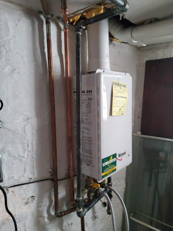 Performed descaling maintenance service on a Rinnai tankless natural gas water heater to remove mineral buildup and restore optimal efficiency. Isolated the unit using shut-off valves, connected descaling pump with hoses and buckets containing descaling solution, circulated the solution through the heat exchanger to dissolve scale deposits, flushed the system thoroughly, and verified proper operation upon completion.