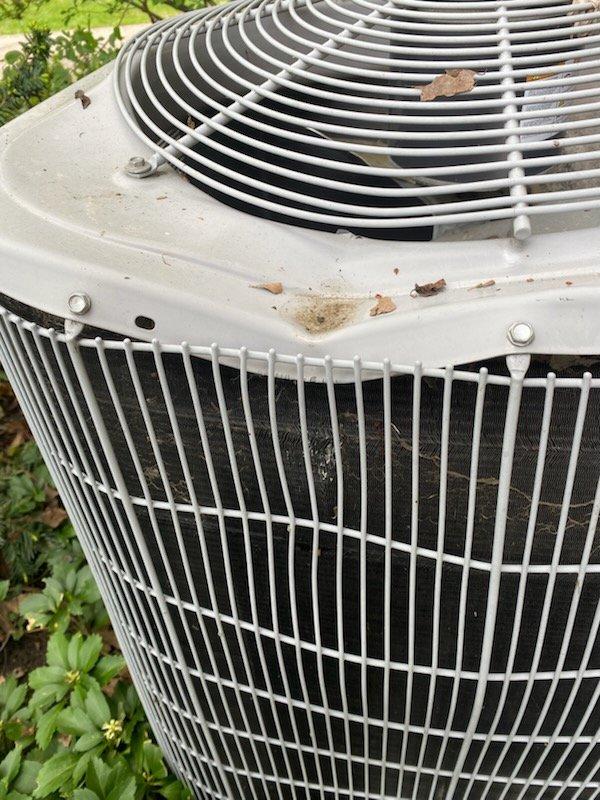 Responded to service call for 5-year-old air conditioning unit rendered inoperable after impact from falling ice caused severe denting to top housing, preventing fan blade rotation. Upon inspection, documented extensive physical damage to condenser unit cabinet and fan guard assembly with photographic evidence. Unit assessed as non-functional due to structural compromise; photos forwarded to management for evaluation regarding repair feasibility versus replacement recommendation.