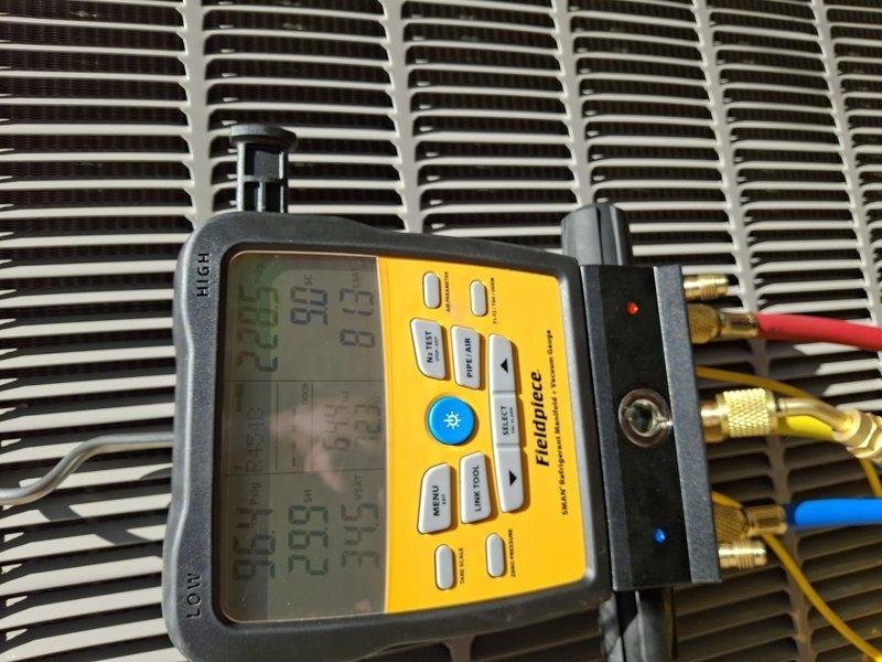 Performed comprehensive cooling system maintenance on basement-located HVAC unit. Inspected evaporator coil assembly, which displayed normal condensation on drip pan and clean coil fins with proper airflow. Utilized Fieldpiece diagnostic gauges to measure and verify refrigerant pressures and system performance parameters. Examined condenser coil, confirming clean fins and proper heat exchange capability. All system components operating within manufacturer specifications with no deficiencies noted.