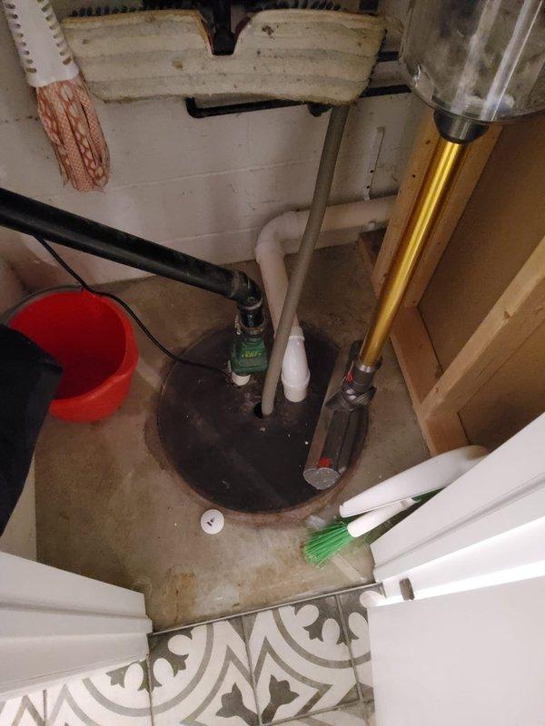 Conducted on-site assessment for tankless water heater installation and sump pump replacement. Evaluated existing sump pump basin configuration, which currently contains operational pump motor with discharge piping system including brass vertical discharge line and PVC components. Documented electrical supply routing through conduit system mounted on cinder block foundation wall with junction box. Assessed basement utility area conditions, concrete floor surfaces, and existing plumbing infrastructure to determine optimal placement and venting requirements for tankless water heater unit. Provided comprehensive estimate covering equipment specifications, installation labor, necessary code-compliant modifications to gas lines, water supply connections, venting system, electrical requirements, and sump pump replacement with updated discharge configuration.