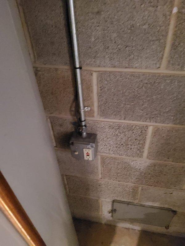 Conducted on-site assessment for tankless water heater installation and sump pump replacement. Evaluated existing sump pump basin configuration, which currently contains operational pump motor with discharge piping system including brass vertical discharge line and PVC components. Documented electrical supply routing through conduit system mounted on cinder block foundation wall with junction box. Assessed basement utility area conditions, concrete floor surfaces, and existing plumbing infrastructure to determine optimal placement and venting requirements for tankless water heater unit. Provided comprehensive estimate covering equipment specifications, installation labor, necessary code-compliant modifications to gas lines, water supply connections, venting system, electrical requirements, and sump pump replacement with updated discharge configuration.