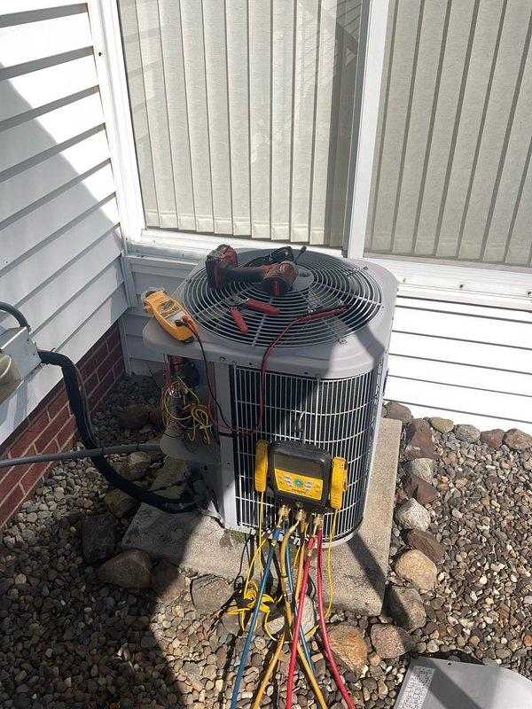 # AC Maintenance Completed

Performed comprehensive air conditioning maintenance on outdoor condensing unit. Connected digital manifold gauge set with refrigerant hoses to service ports to measure system pressures and temperatures. Utilized Fieldpiece SMAN diagnostic equipment to evaluate refrigerant charge levels, superheat, and subcooling values. Readings indicated system operating parameters were within acceptable range at 212.1°F discharge temperature with corresponding pressure readings of 313 PSIG. Conducted electrical testing with digital multimeter to verify proper voltage and amperage to compressor and condenser fan motor. All electrical components tested within manufacturer specifications. Inspected condenser coil fins for debris and damage, confirmed adequate airflow through unit. Verified fan motor operation and blade condition. System operating efficiently with no refrigerant leaks detected and proper cooling capacity restored.