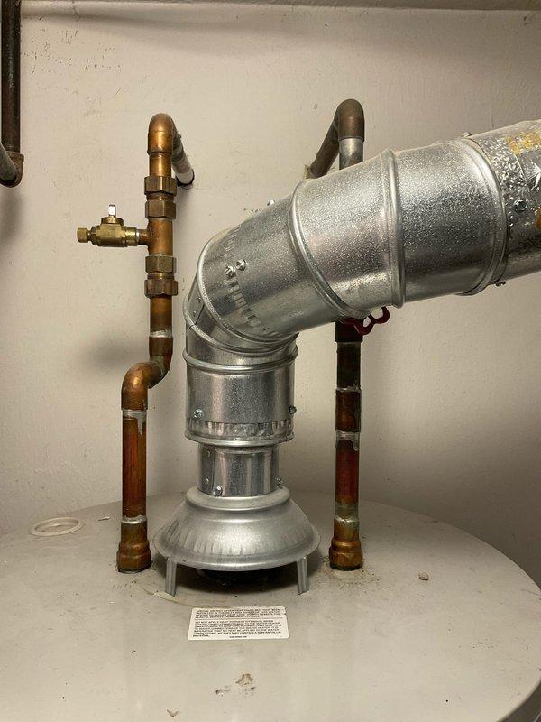 Performed flush and fill service on natural gas tanked water heater. Drained sediment buildup from tank through drain valve, flushed system with fresh water to remove mineral deposits and debris, then refilled unit to proper operating level. Inspected copper supply lines, brass shutoff valves, and connection fittings for leaks or corrosion—all found to be in functional condition with normal patina present on older piping. Provided quote for anode rod replacement to extend tank lifespan and prevent premature corrosion failure. Verified proper water flow and temperature upon completion.