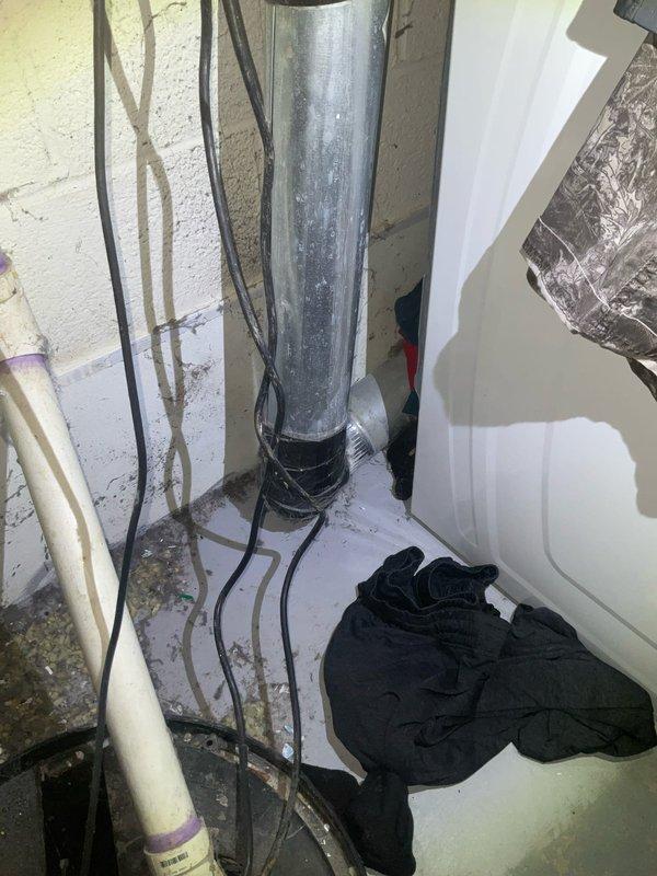 Completed comprehensive plumbing assessment of basement utility systems, including inspection of sump pump discharge piping and dryer vent configuration. Documented existing ductwork conditions, noting vertical metallic duct installation with flexible connectors, PVC drainage piping, and HVAC components with photographic evidence for customer reference and future service planning.